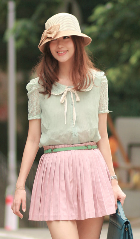 Mayo wearing pleated chiffon shirt